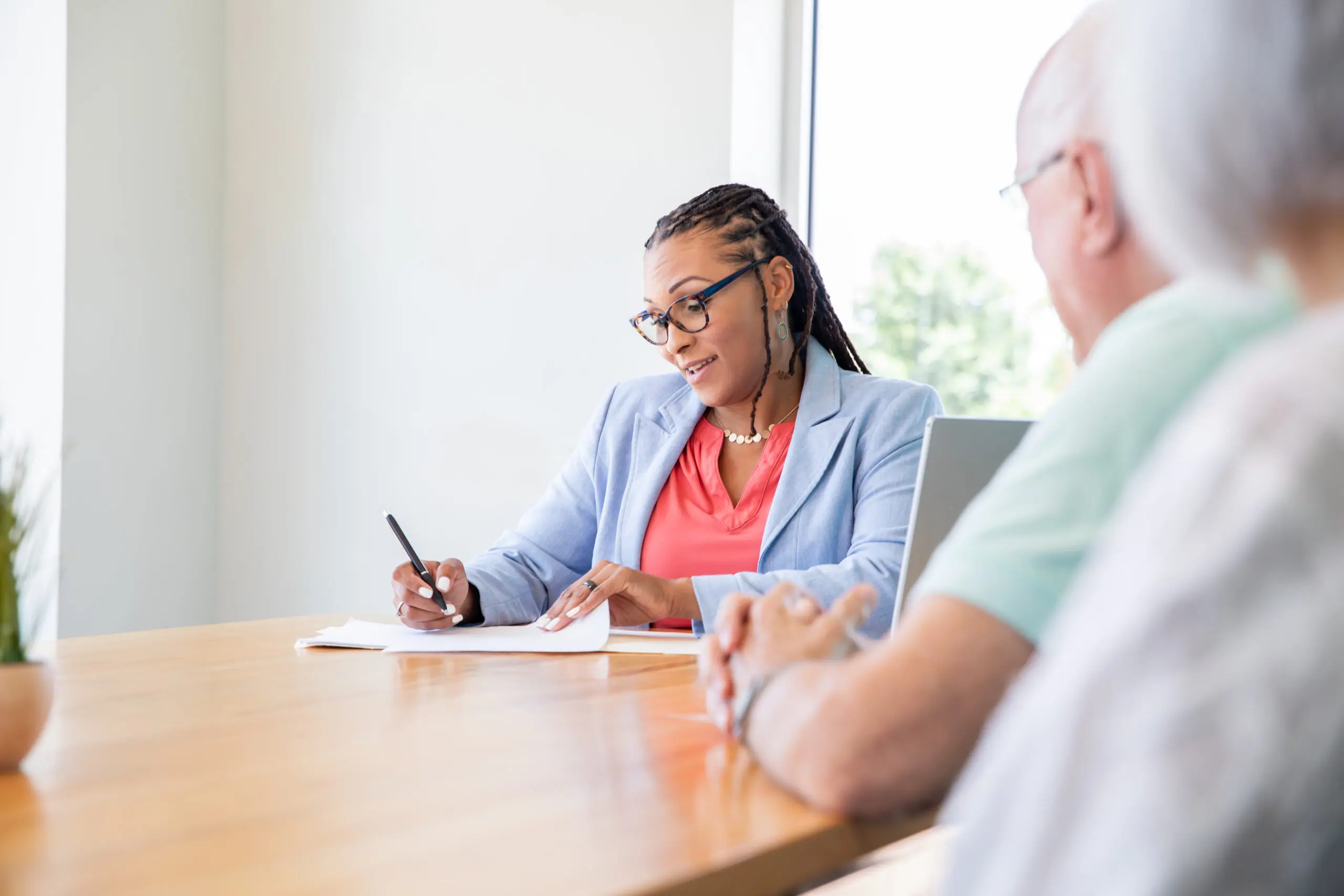 Attorney or title agent meets with senior clients to finalize sale of their home